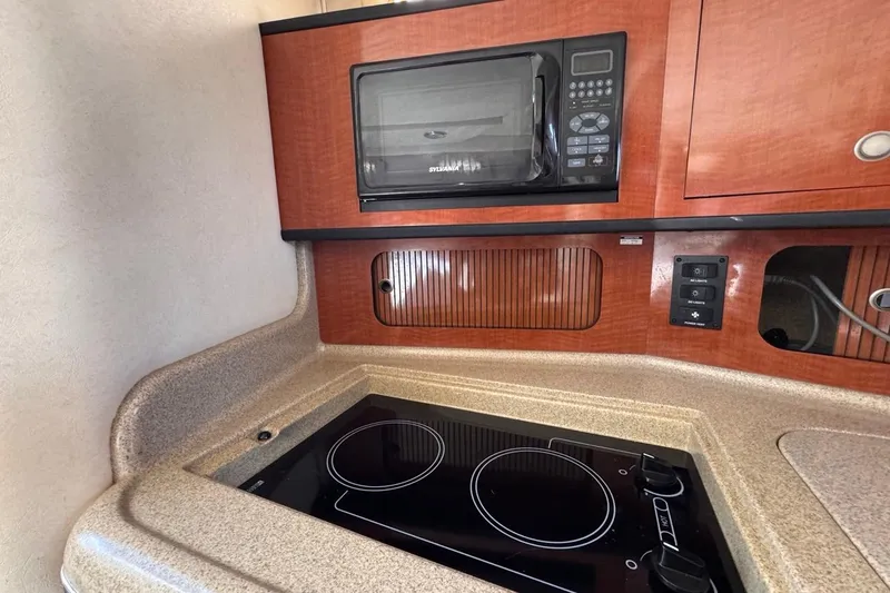 Slide: The Image of Compact kitchen area in 2005 Sea Ray 300 Sundancer with stove and microwave. - 66