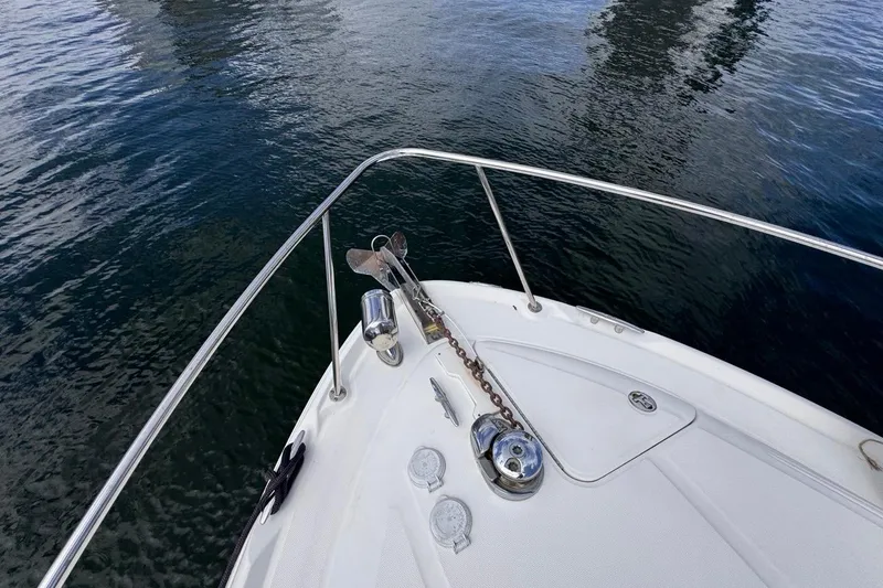 Slide: The Image of Bow of 2005 Sea Ray 300 Sundancer with anchor and calm water view. - 42