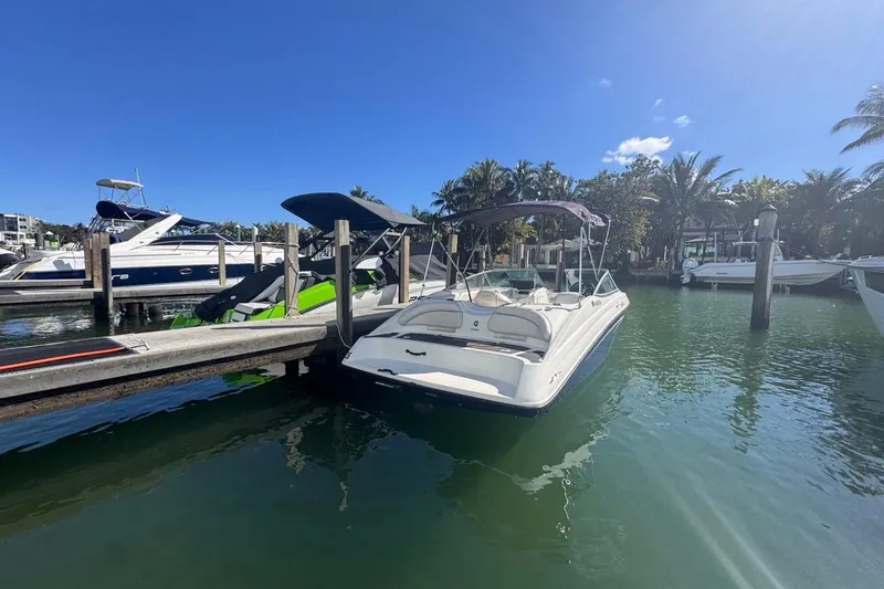 Slide: The Image of 2012 Yamaha Boats SX190 docked in a sunny marina with palm trees. - 1