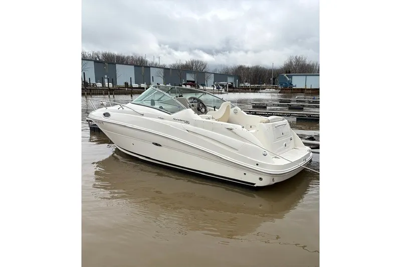 The Image of 2013 Sea Ray 240 Sundancer boat docked on a cloudy day. - 0