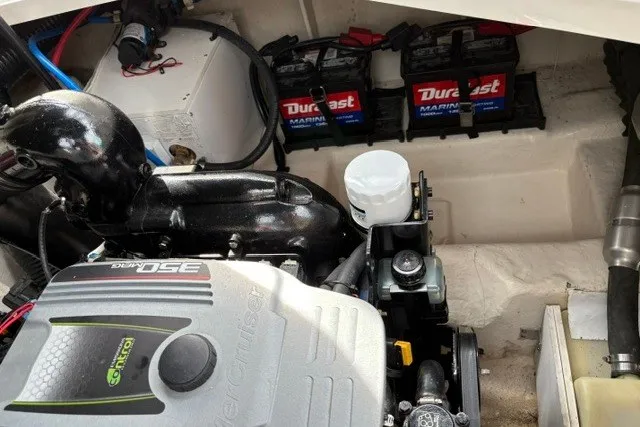 Slide: The Image of Engine compartment of a 2013 Sea Ray 240 Sundancer with Duralast marine batteries. - 19
