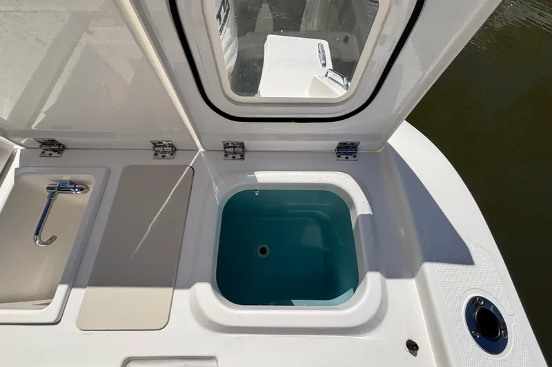 Slide: The Image of 2024 Pursuit OS 445 Offshore boat deck with open storage compartment. - 48
