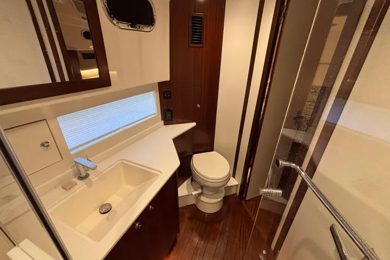 Slide: The Image of Luxurious bathroom in 2024 Pursuit OS 445 Offshore yacht with modern fixtures and wood accents. - 109