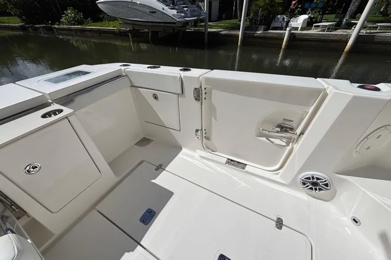 Slide: The Image of 2024 Pursuit OS 445 Offshore boat deck with storage compartments and sleek design. - 46
