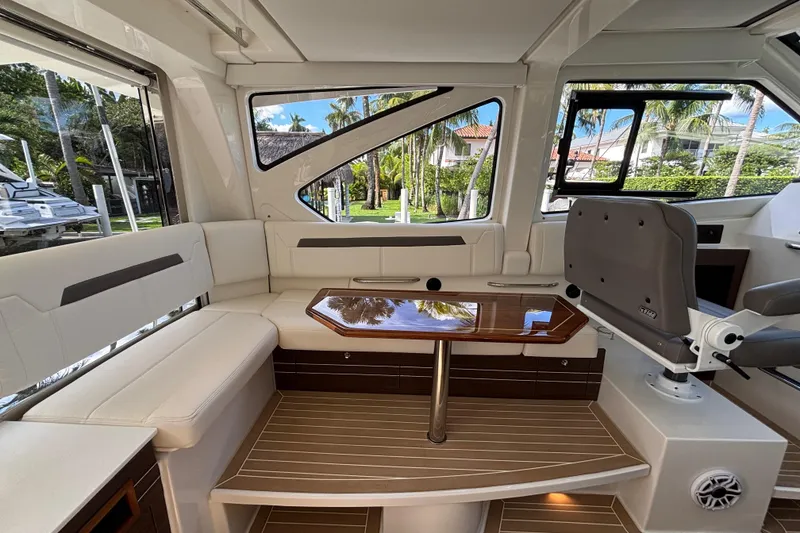 Slide: The Image of 2024 Pursuit OS 445 Offshore interior with elegant seating and polished wood table. - 70