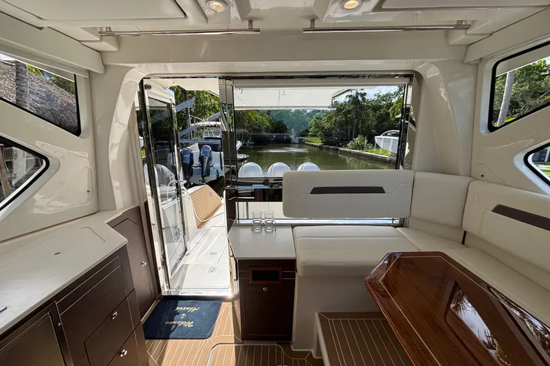 Slide: The Image of Luxurious interior of 2024 Pursuit OS 445 Offshore yacht with elegant seating and scenic water view. - 69