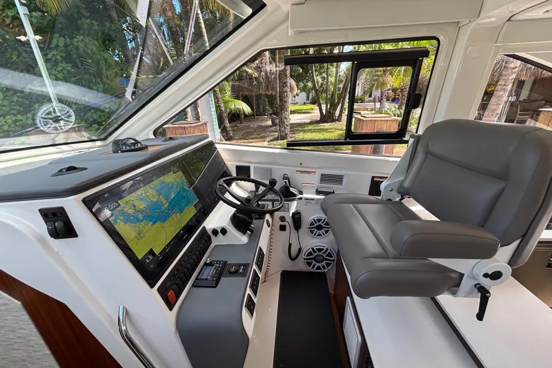 Slide: The Image of 2024 Pursuit OS 445 Offshore helm with advanced navigation system and comfortable seating. - 86