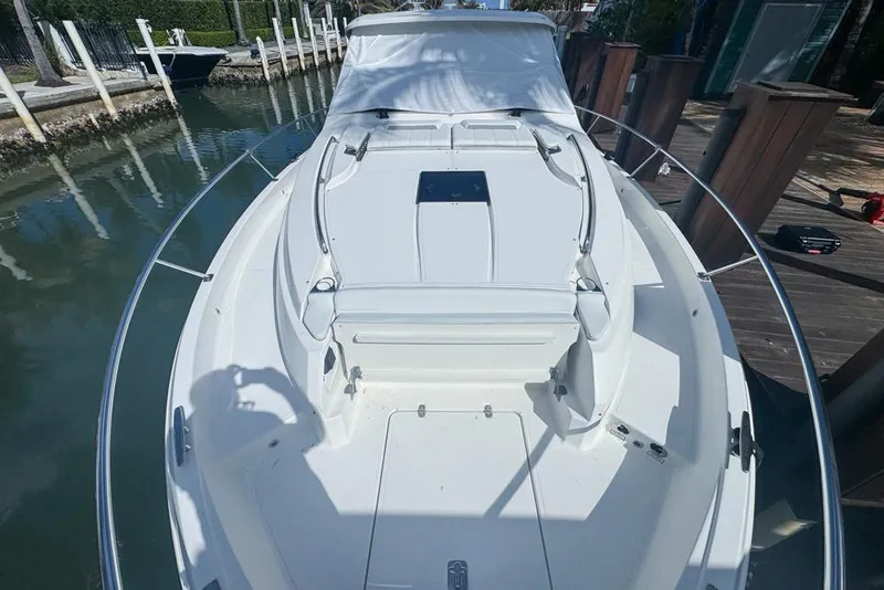 Slide: The Image of 2024 Pursuit OS 445 Offshore boat docked, showcasing sleek white deck design. - 17