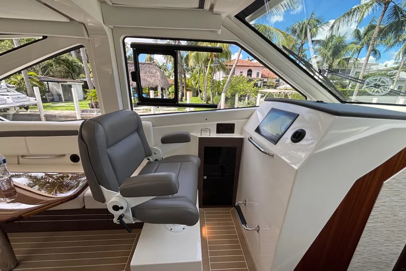 Slide: The Image of 2024 Pursuit OS 445 Offshore helm with luxurious seating and advanced navigation system. - 90