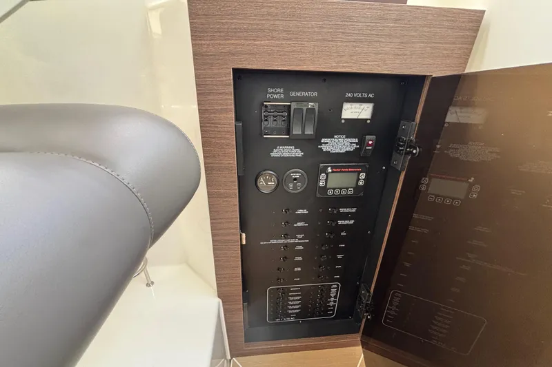 Slide: The Image of Electrical panel of 2024 Pursuit OS 445 Offshore boat, featuring switches and controls. - 96