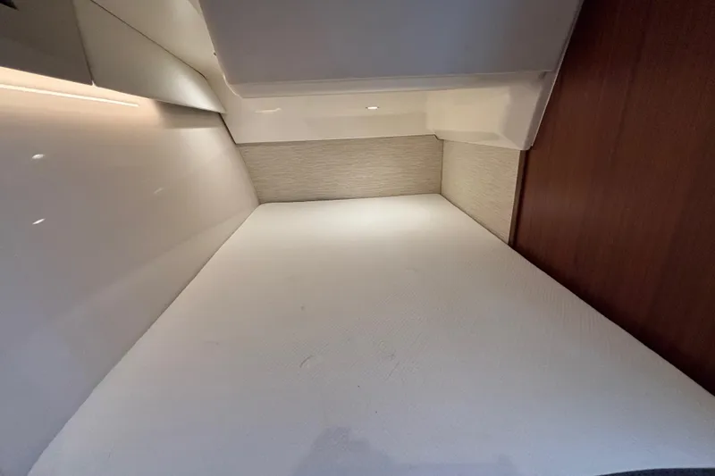 Slide: The Image of 2024 Pursuit OS 445 Offshore cabin interior with modern design and ambient lighting. - 113