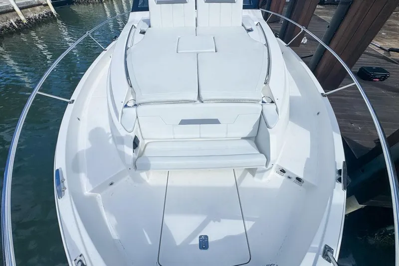 Slide: The Image of 2024 Pursuit OS 445 Offshore boat with spacious white seating area. - 133