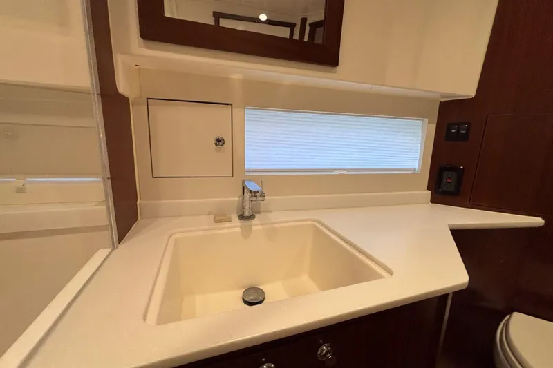 Slide: The Image of 2024 Pursuit OS 445 Offshore yacht bathroom with modern sink and sleek countertop design. - 107