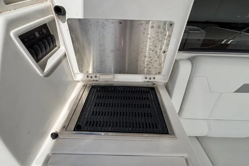 Slide: The Image of 2024 Pursuit OS 445 Offshore boat grill and control panel detail. - 54