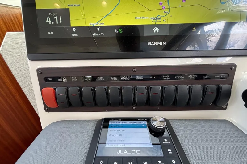 Slide: The Image of 2024 Pursuit OS 445 Offshore dashboard with Garmin navigation and JL Audio system. - 79