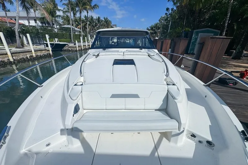 Slide: The Image of 2024 Pursuit OS 445 Offshore boat docked, showcasing sleek design and spacious deck. - 23