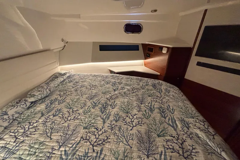 Slide: The Image of 2024 Pursuit OS 445 Offshore cabin with a cozy bed and elegant interior design. - 103