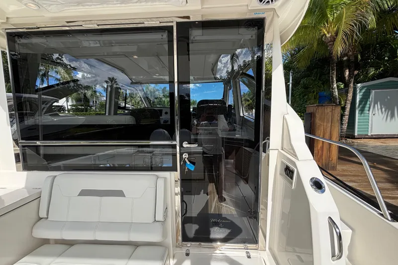 Slide: The Image of 2024 Pursuit OS 445 Offshore yacht interior with sleek design and luxurious seating. - 62