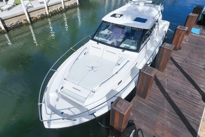 Slide: The Image of 2024 Pursuit OS 445 Offshore boat docked in marina, aerial view. - 10