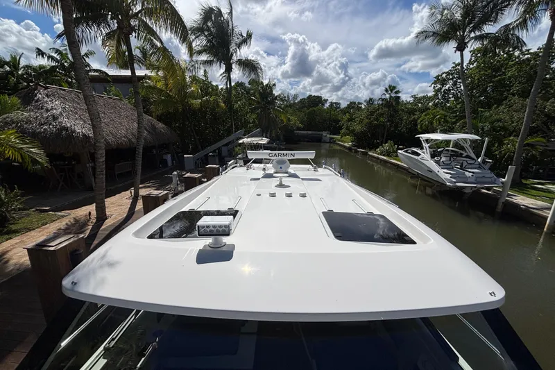 Slide: The Image of 2024 Pursuit OS 445 Offshore yacht docked in tropical canal setting. - 35