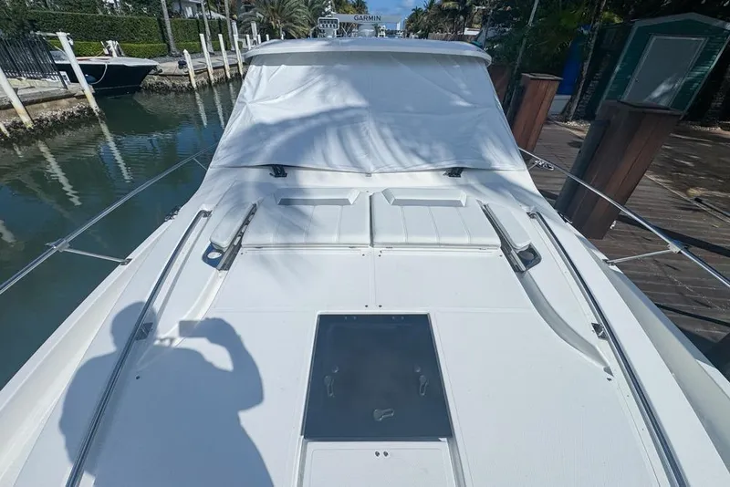 Slide: The Image of 2024 Pursuit OS 445 Offshore boat docked, showcasing sleek deck design and modern features. - 20