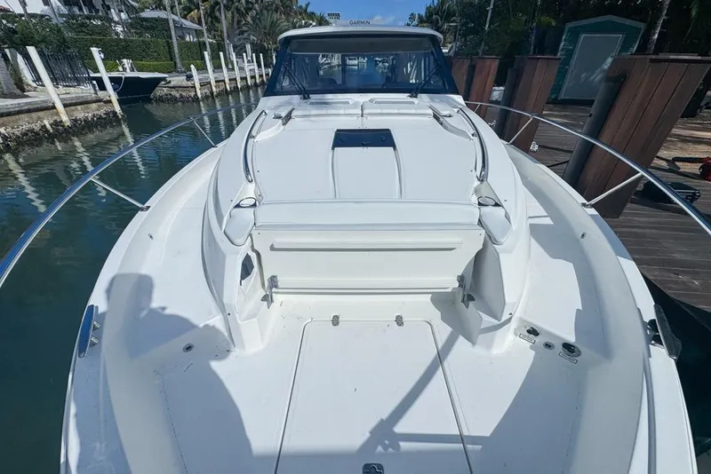 Slide: The Image of 2024 Pursuit OS 445 Offshore boat docked, showcasing spacious deck and sleek design. - 22