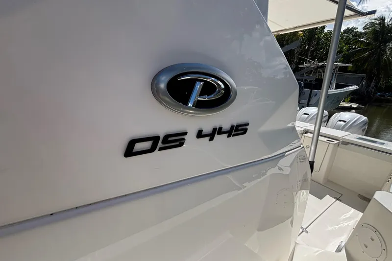Slide: The Image of 2024 Pursuit OS 445 Offshore boat, close-up of model emblem and deck area. - 38