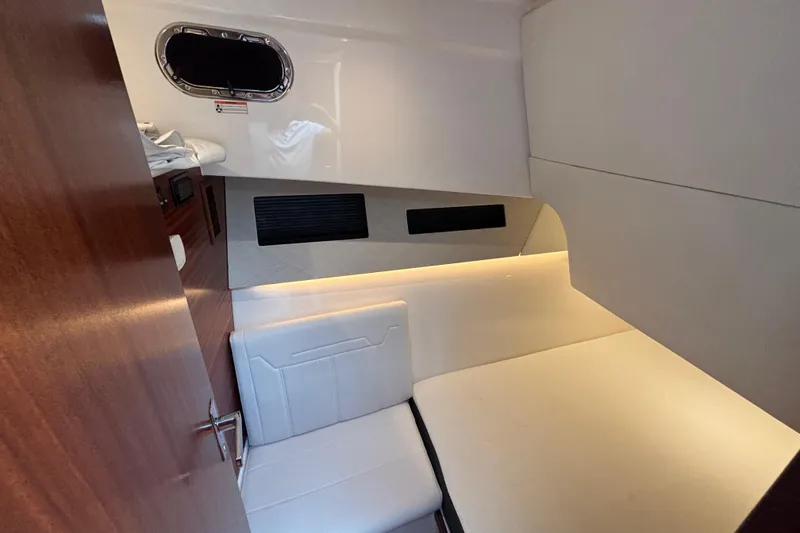 Slide: The Image of 2024 Pursuit OS 445 Offshore cabin interior with modern seating and ambient lighting. - 112