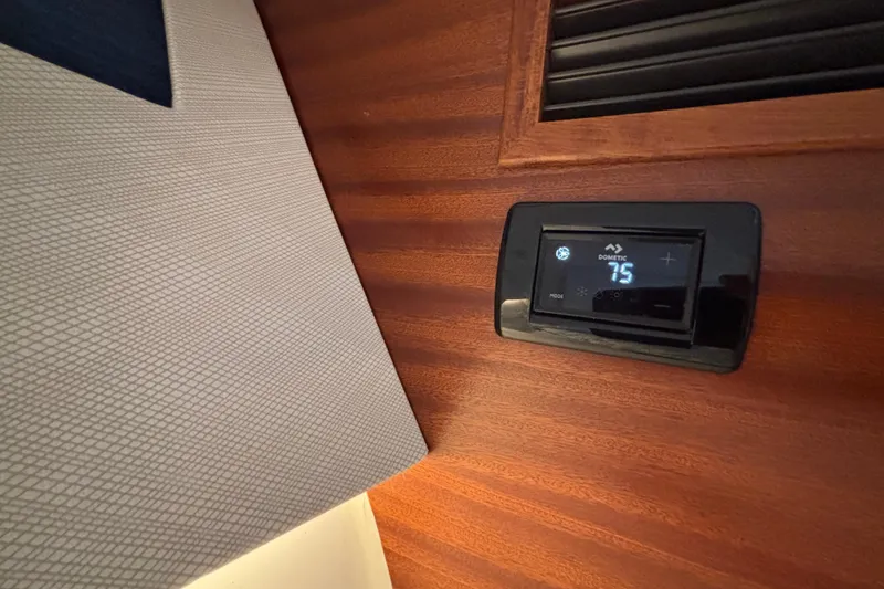 Slide: The Image of Thermostat display on 2024 Pursuit OS 445 Offshore boat interior, showing 75 degrees. - 111