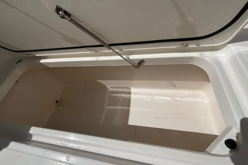 Slide: The Image of Open storage compartment on 2024 Pursuit OS 445 Offshore boat, showcasing interior space. - 57
