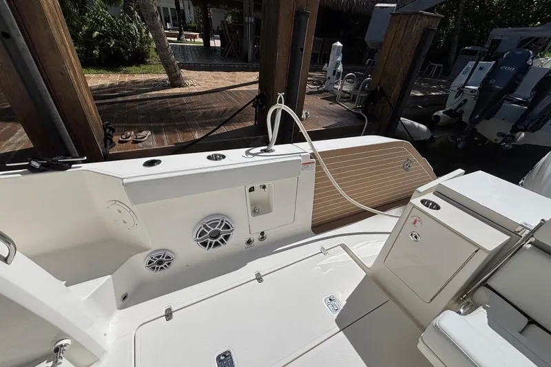 Slide: The Image of 2024 Pursuit OS 445 Offshore boat deck with speakers and storage compartments. - 45
