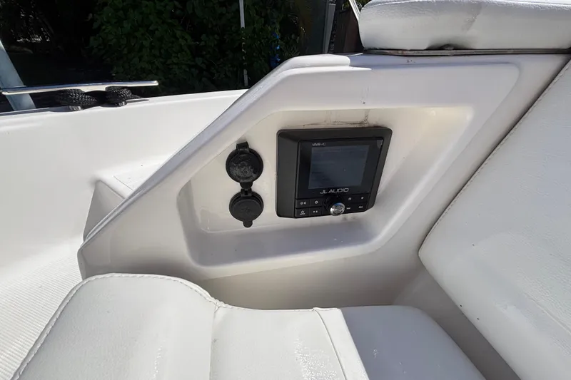 Slide: The Image of 2024 Pursuit OS 445 Offshore boat interior with JL Audio system and white seating. - 27