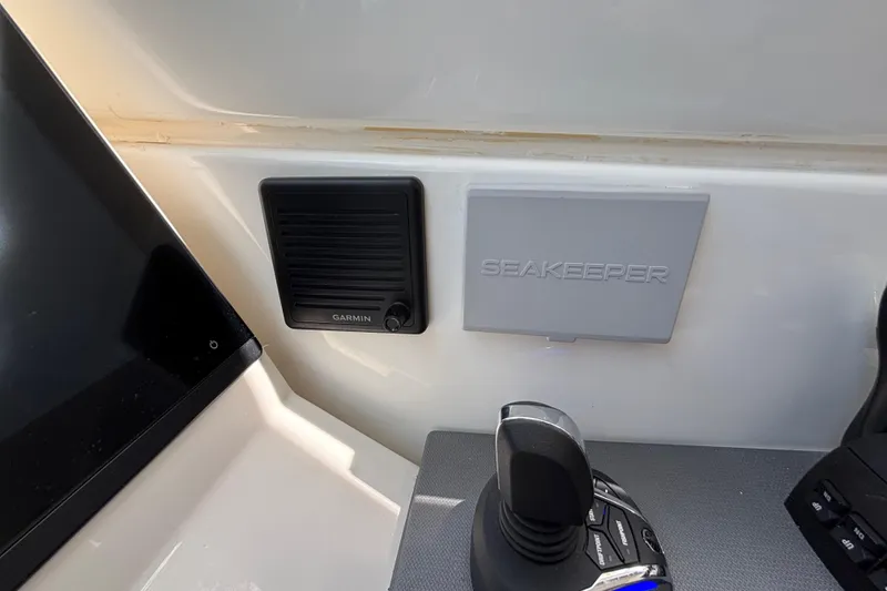 Slide: The Image of Control panel of 2024 Pursuit OS 445 Offshore with Garmin and Seakeeper systems. - 97
