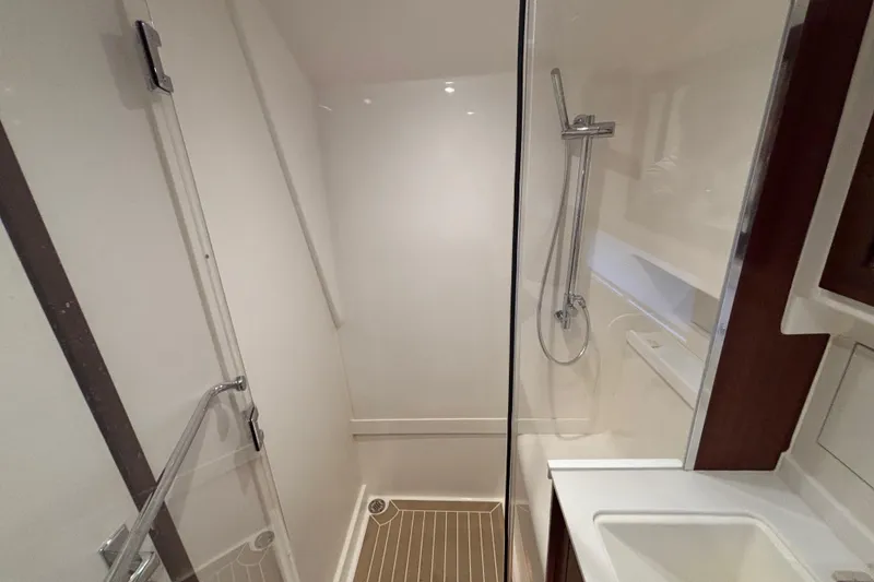 Slide: The Image of 2024 Pursuit OS 445 Offshore yacht bathroom with modern shower and sleek design. - 110