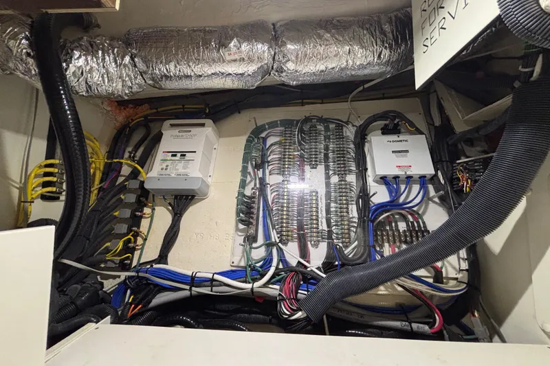 Slide: The Image of Electrical system of 2024 Pursuit OS 445 Offshore boat, featuring wiring and control panels. - 119