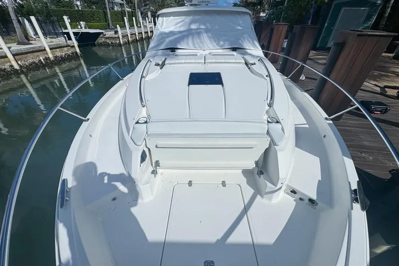Slide: The Image of 2024 Pursuit OS 445 Offshore boat docked, showcasing spacious deck and sleek design. - 18