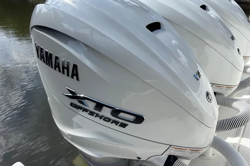 Slide: The Image of 2024 Pursuit OS 445 Offshore with Yamaha XTO Offshore engines, docked on water. - 61
