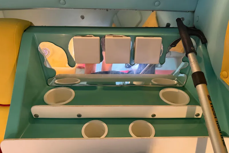 Slide: The Image of Interior of 2011 Apache 28 Splash boat with cup holders and a walking cane. - 62
