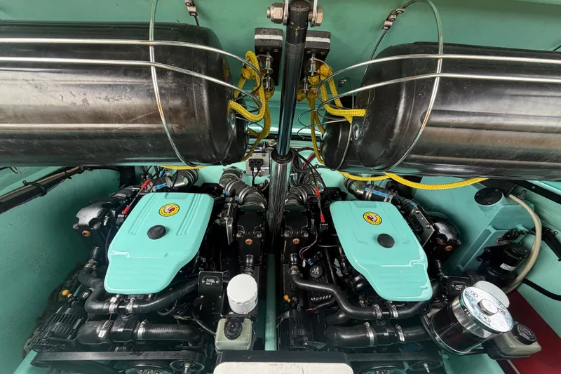 Slide: The Image of Engine compartment of a 2011 Apache 28 Splash boat, showcasing dual engines and components. - 96