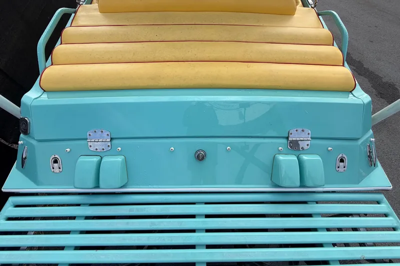 Slide: The Image of Rear view of an Apache 28 Splash boat with turquoise hull and yellow upholstery. - 14