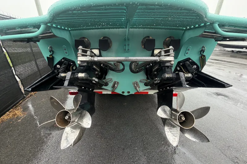 Slide: The Image of Rear view of 2011 Apache 28 Splash boat with dual propellers on wet pavement. - 3