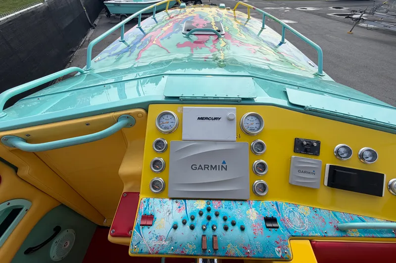 Slide: The Image of Colorful dashboard of a 2011 Apache 28 Splash boat with Garmin and Mercury instruments. - 41
