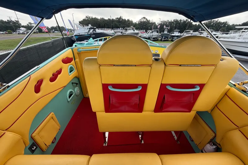 Slide: The Image of Colorful interior of a 2011 Apache 28 Splash boat with vibrant seating and dashboard. - 19