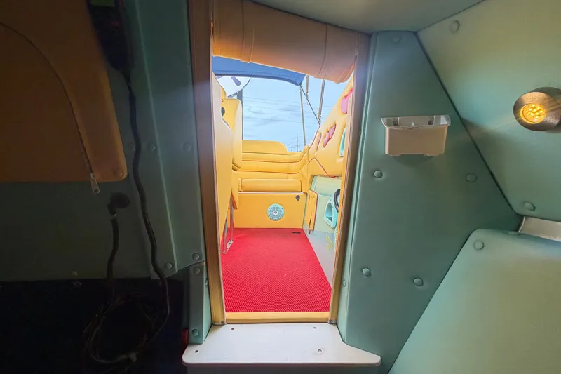 Slide: The Image of Interior view of 2011 Apache 28 Splash boat with vibrant seating and red carpet. - 67