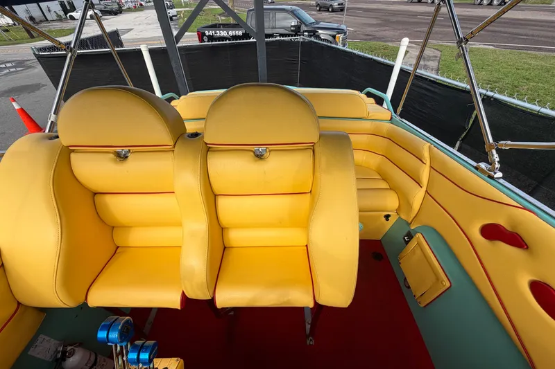 Slide: The Image of Interior of 2011 Apache 28 Splash boat with vibrant yellow seating and red accents. - 78