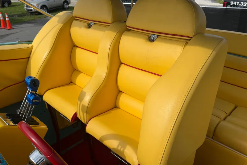 Slide: The Image of Yellow leather seats in a 2011 Apache 28 Splash boat interior. - 79