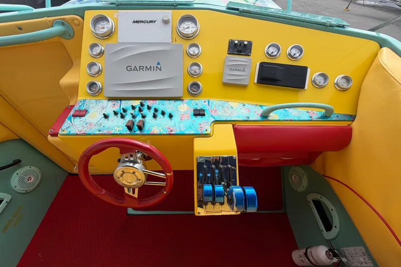 Slide: The Image of Colorful Apache 28 Splash 2011 boat dashboard with Garmin and Mercury instruments. - 23