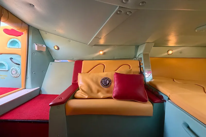Slide: The Image of Interior of 2011 Apache 28 Splash boat with colorful seating and cushions. - 47