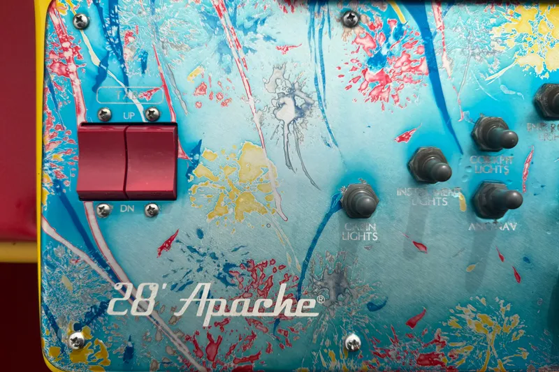 Slide: The Image of Control panel of a 2011 Apache 28 Splash boat with colorful abstract design. - 34