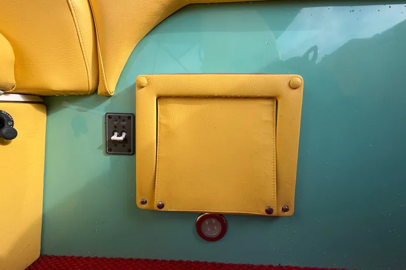 Slide: The Image of Yellow and teal interior of 2011 Apache 28 Splash boat with control panel. - 81